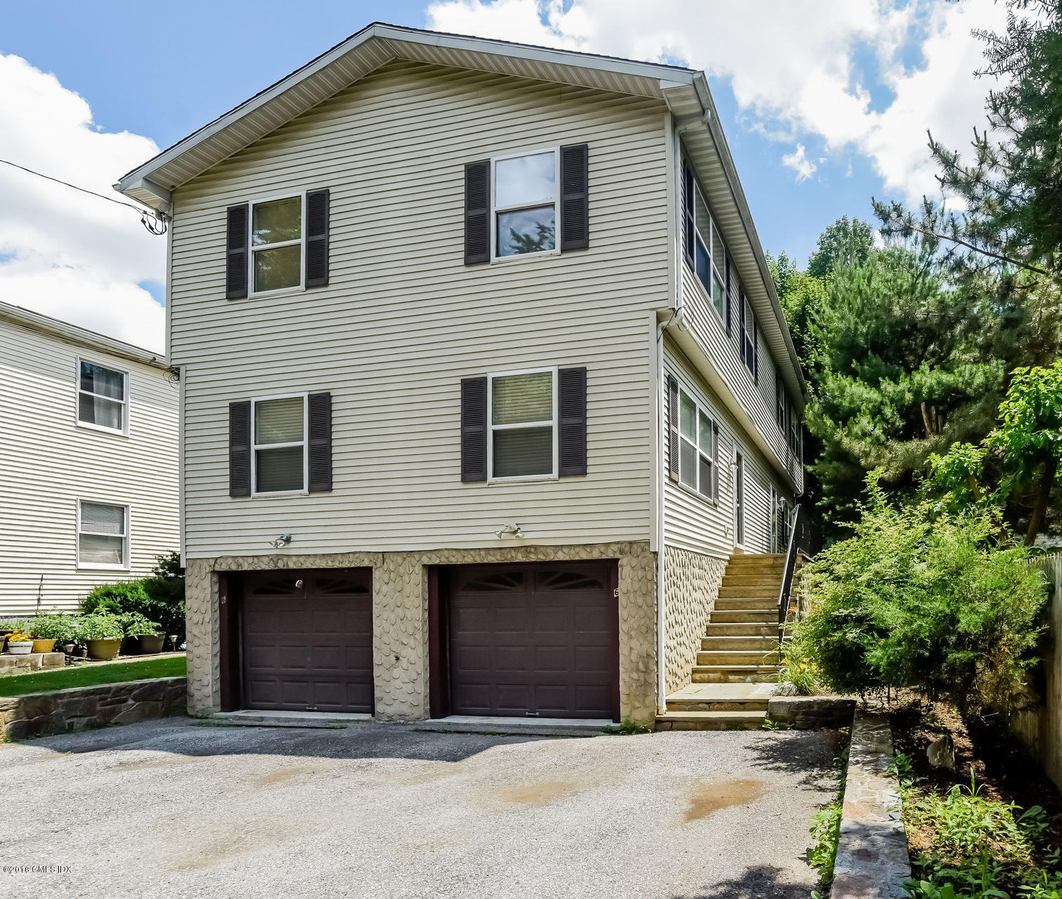 6 Booth Court Greenwich, CT 06830 - Photo 2 of 11 a front view of a house with garage