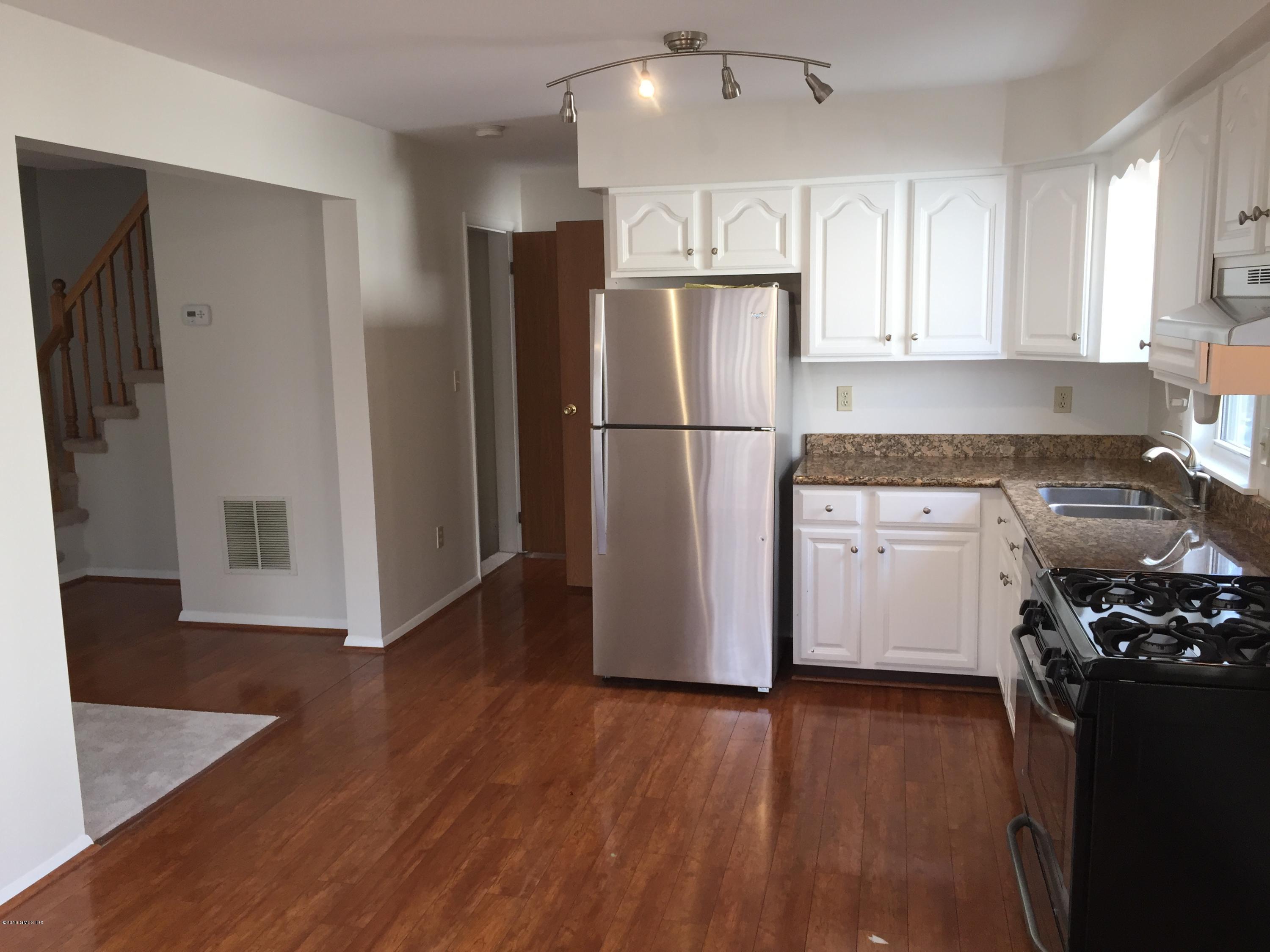6 Booth Court Greenwich, CT 06830 - Photo 3 of 11 a kitchen with a refrigerator and a stove top oven
