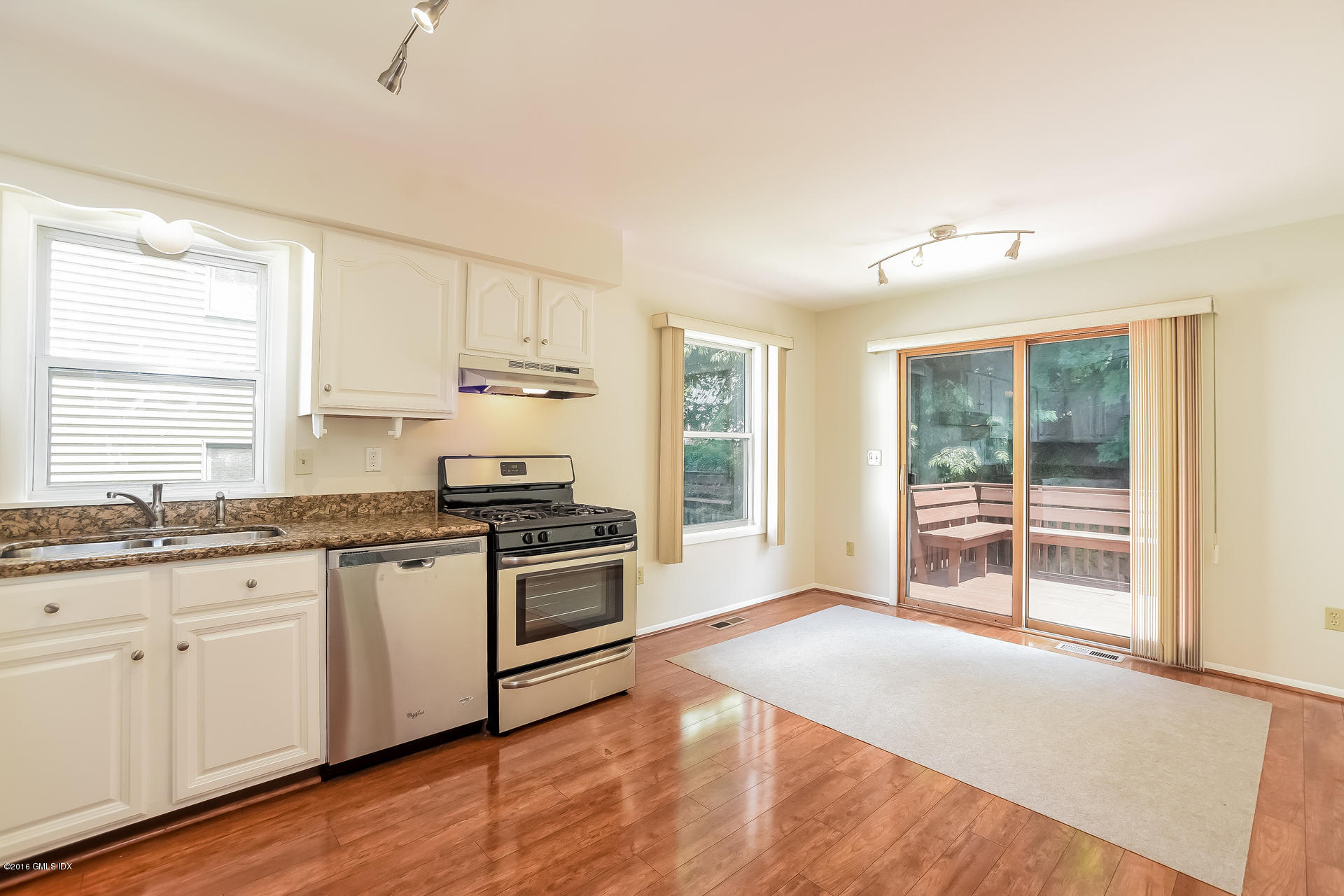 6 Booth Court Greenwich, CT 06830 - Photo 5 of 11 a kitchen with granite countertop a stove a sink and a refrigerator