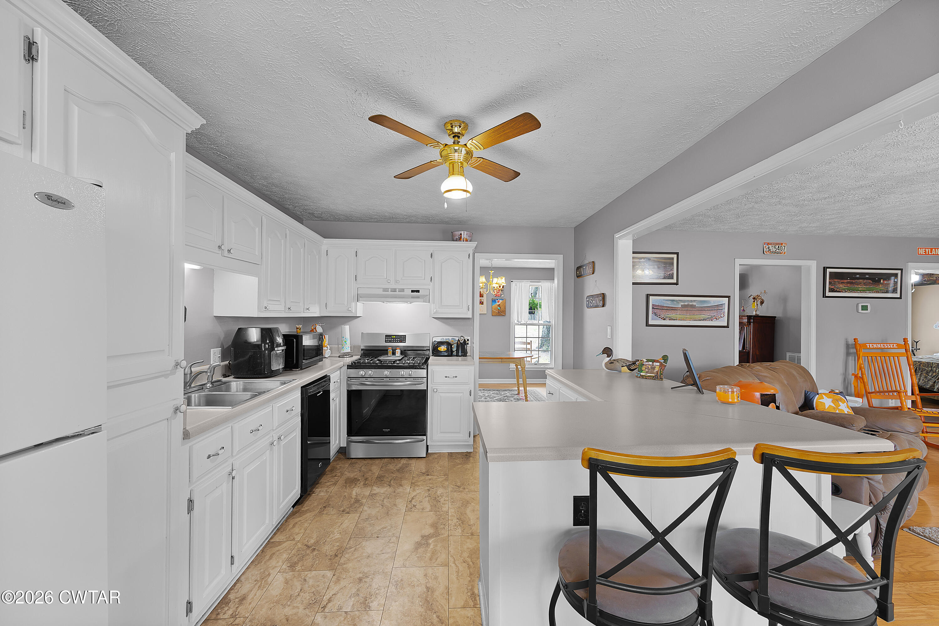 164 Mathis Crossing Road Milan, TN 38358 - Photo 16 of 33 a kitchen with stainless steel appliances granite countertop a stove top oven a sink dishwasher and white cabinets with wooden floor