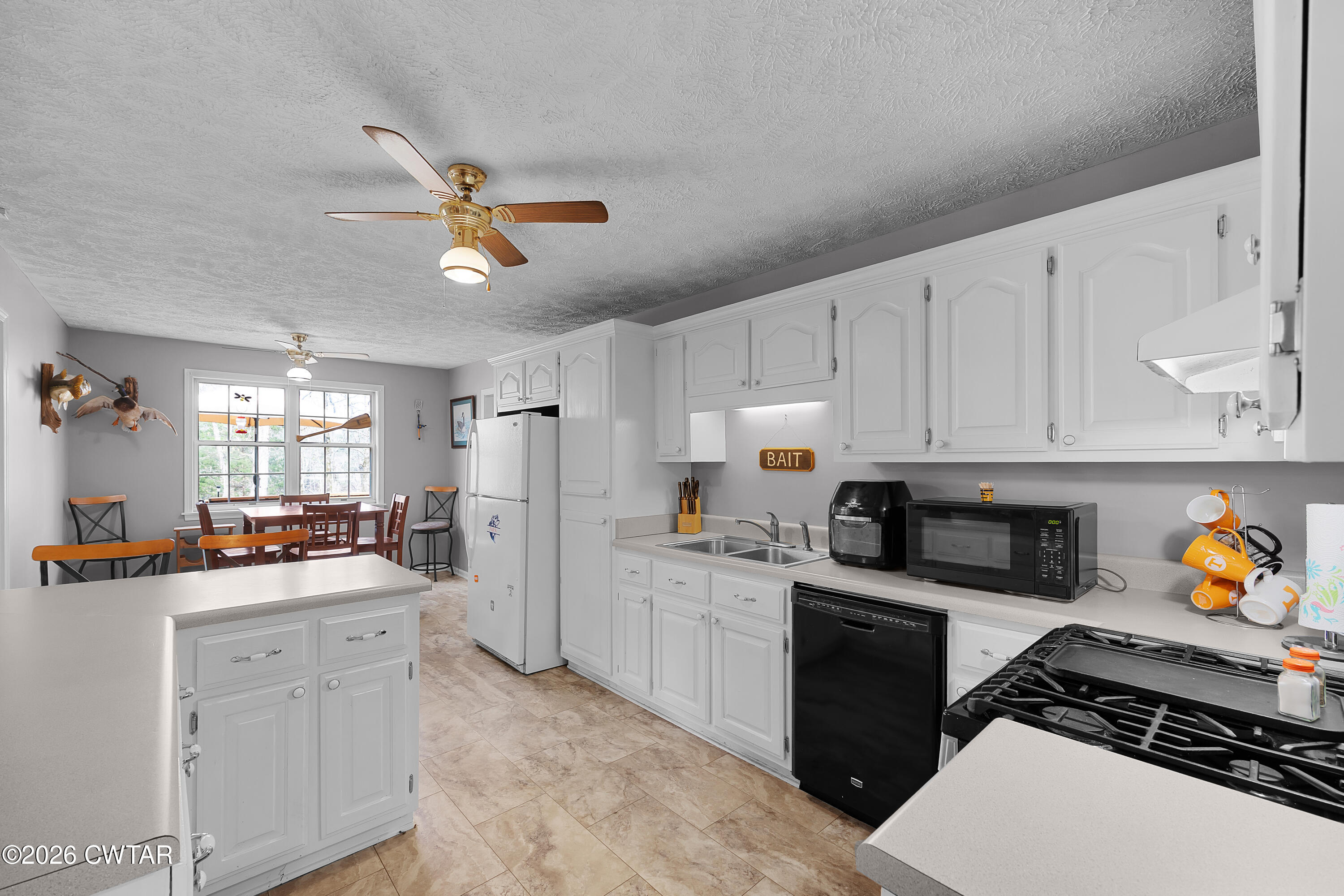 164 Mathis Crossing Road Milan, TN 38358 - Photo 18 of 33 a kitchen with a sink stove and refrigerator