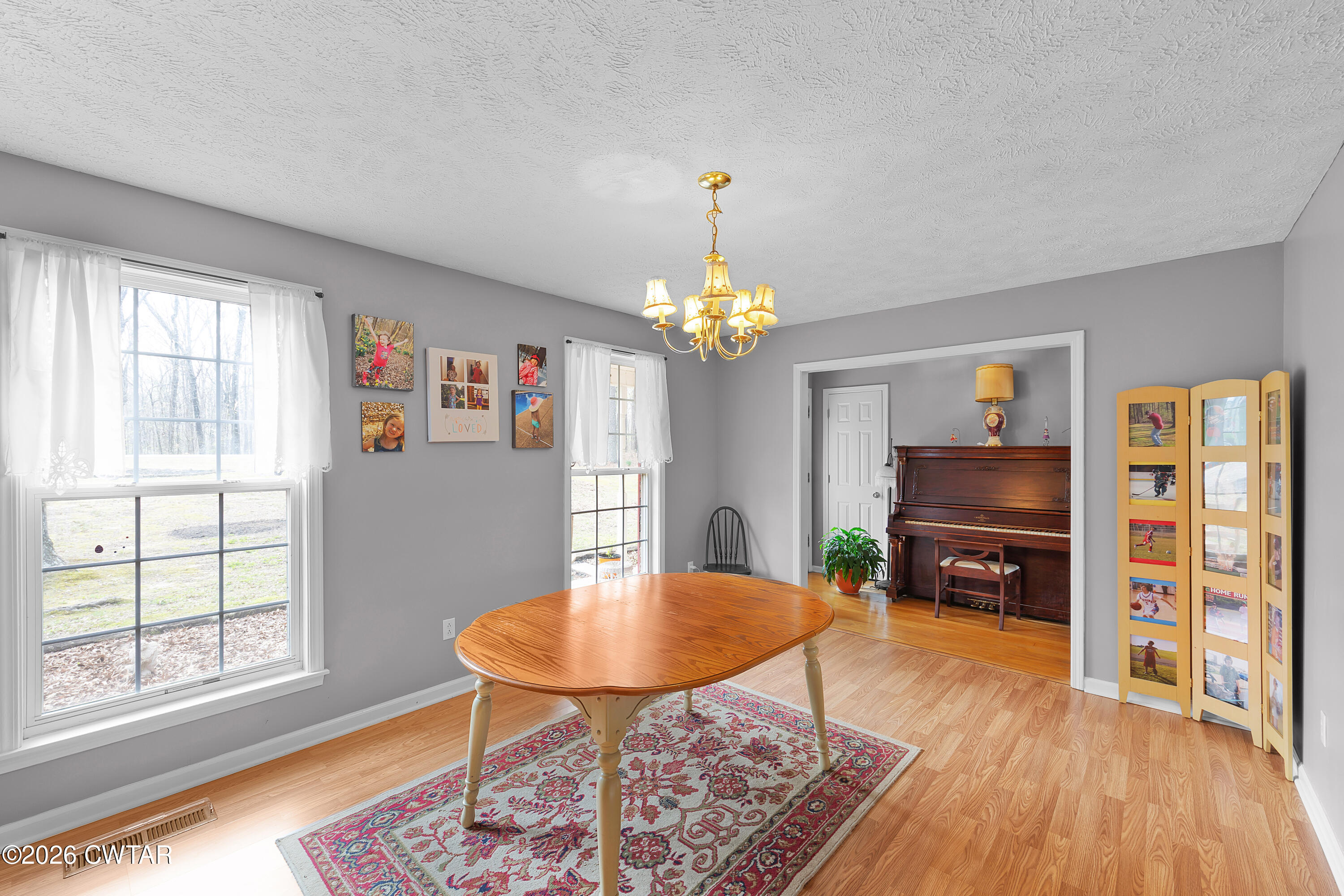 164 Mathis Crossing Road Milan, TN 38358 - Photo 20 of 33 a view of a dining room with furniture a chandelier and wooden floor