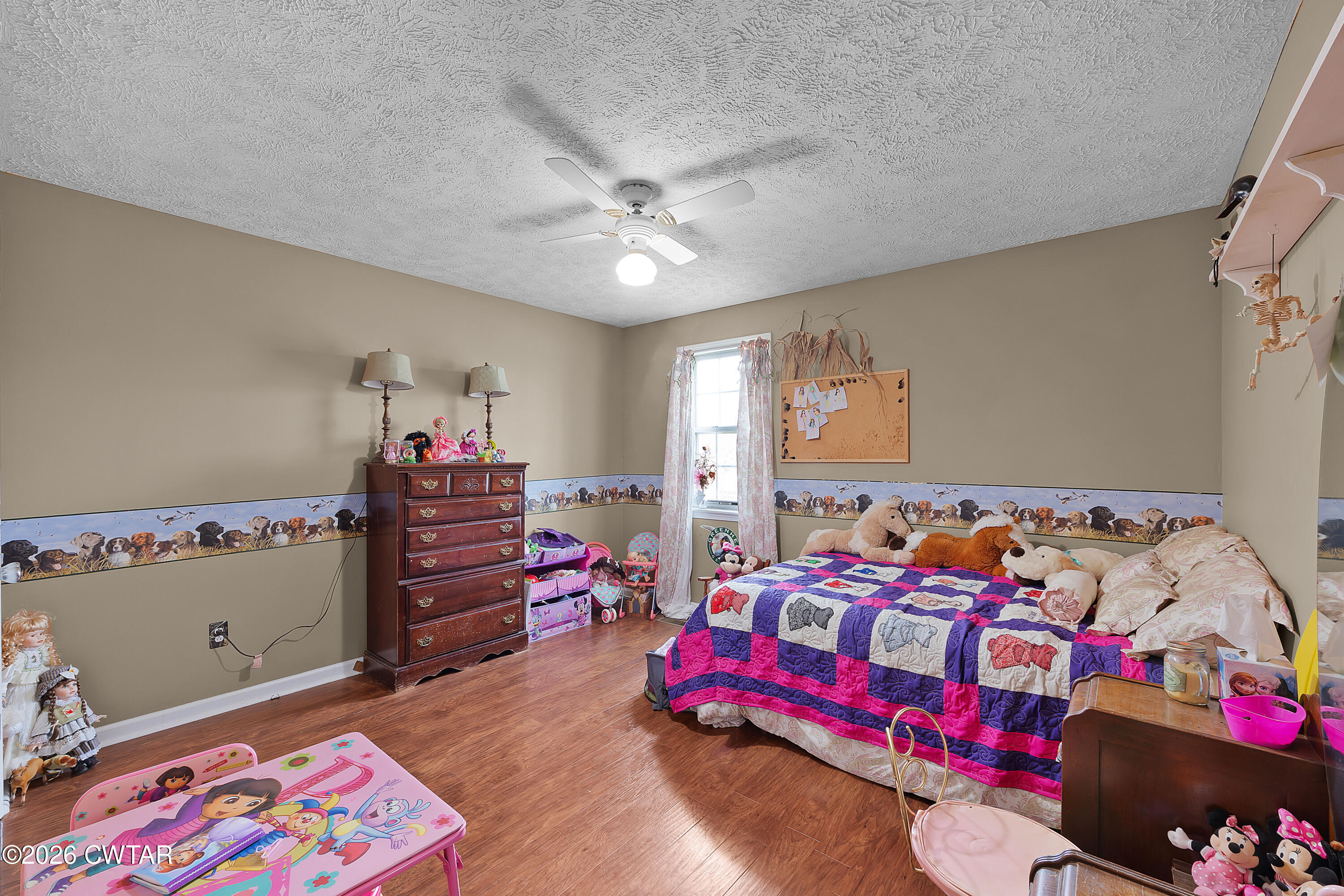 164 Mathis Crossing Road Milan, TN 38358 - Photo 26 of 33 a bedroom with a bed and a dresser in it