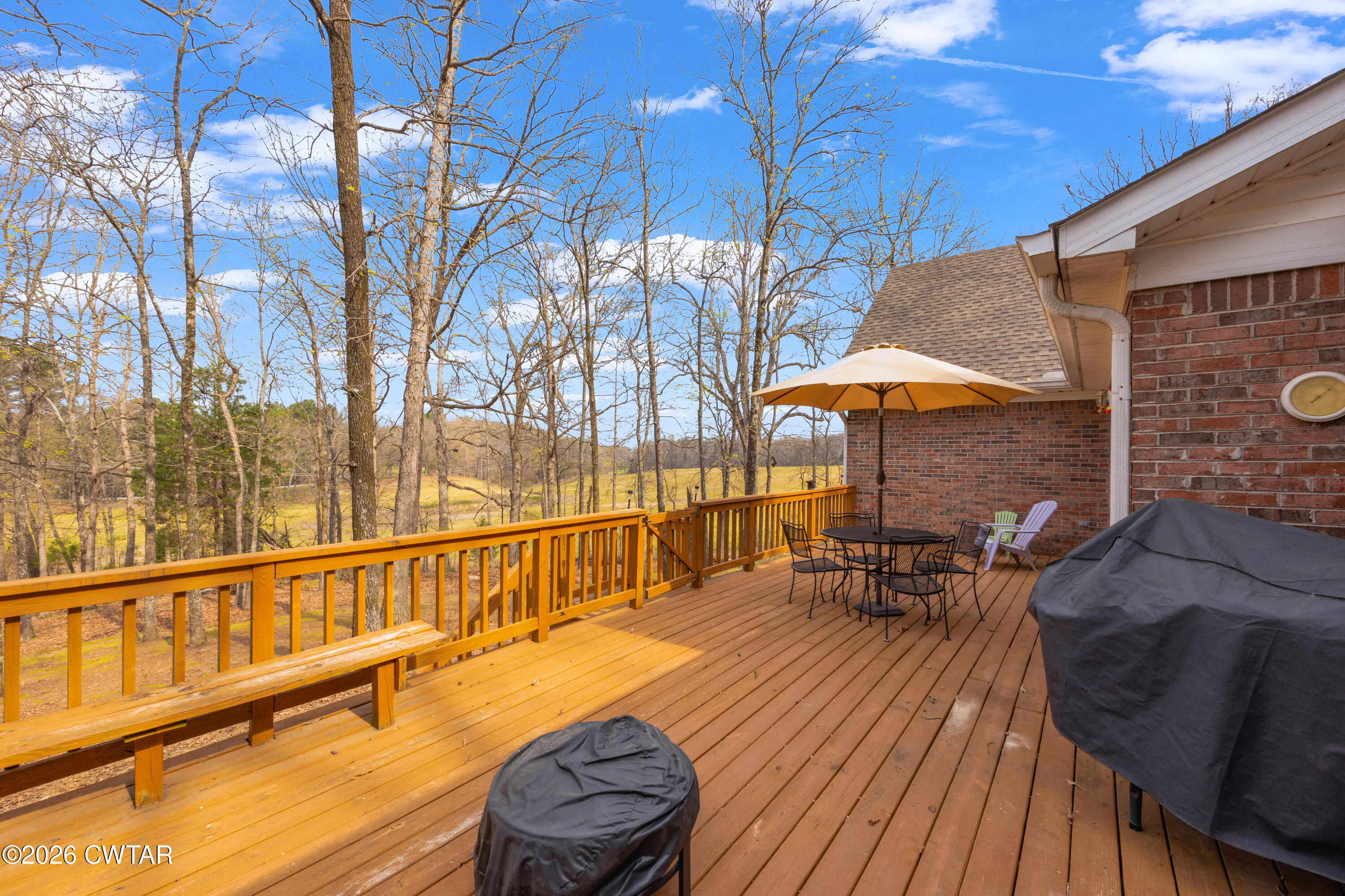 164 Mathis Crossing Road Milan, TN 38358 - Photo 10 of 33 a balcony with table and chairs under an umbrella
