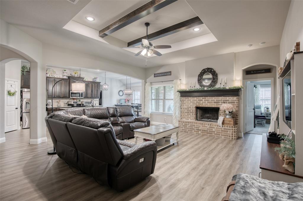 211 Rees Avenue Godley, TX 76044 - Photo 5 of 18 a living room with furniture a clock and a fireplace