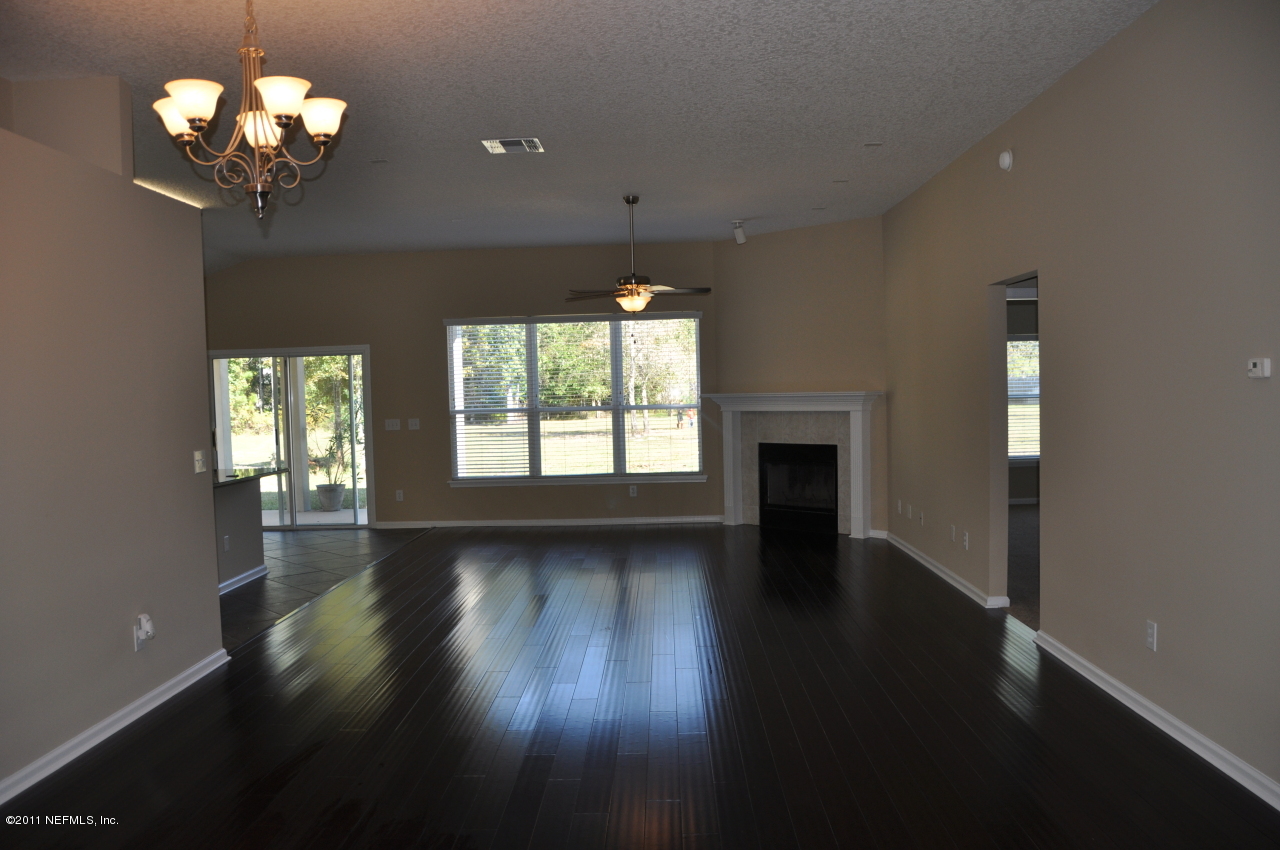 1212 Ribbon Road St. Johns, FL 32259 - Photo 4 of 10 an empty room with wooden floor and windows
