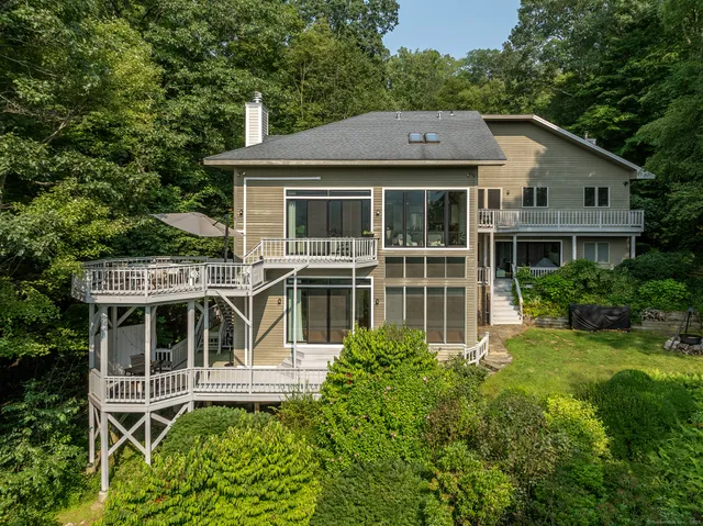 a aerial view of a house with a yard table and chairs