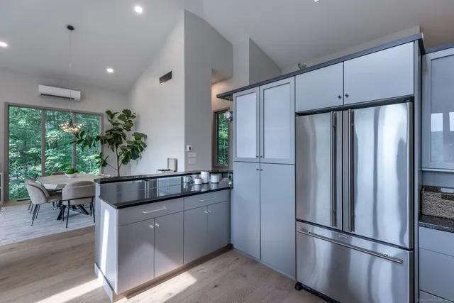 a kitchen with stainless steel appliances granite countertop a refrigerator and a sink