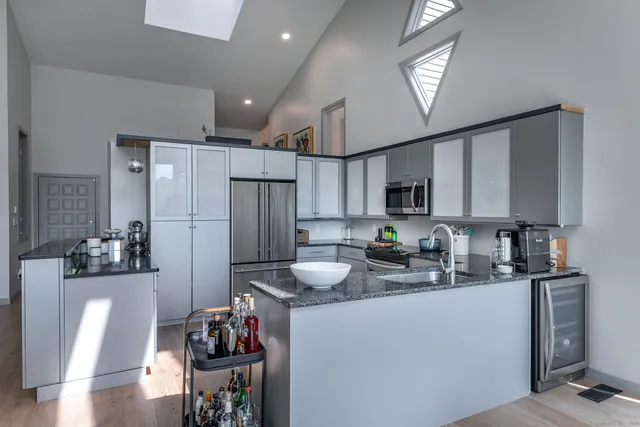 a kitchen with refrigerator and cabinets