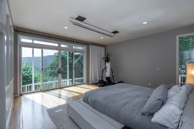 a bedroom with a bed and a large window