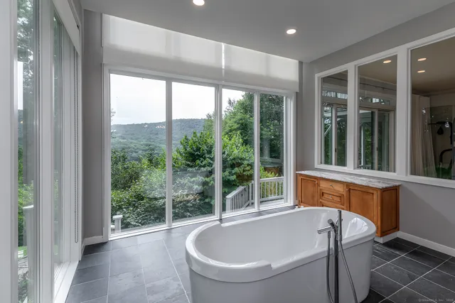 a bathroom with a large tub and large window