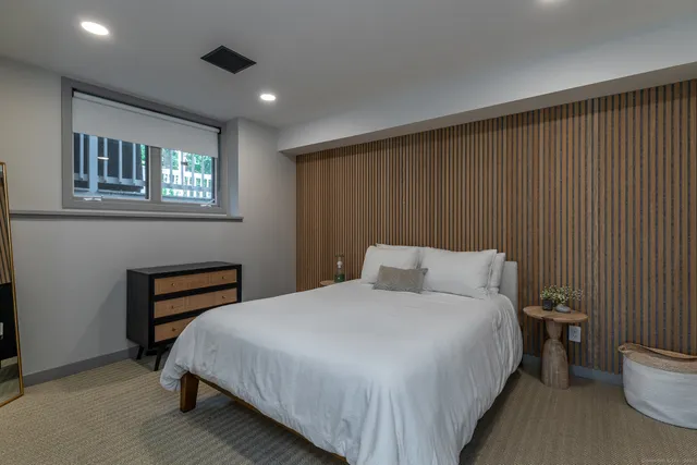 a bedroom with a bed and a night stand