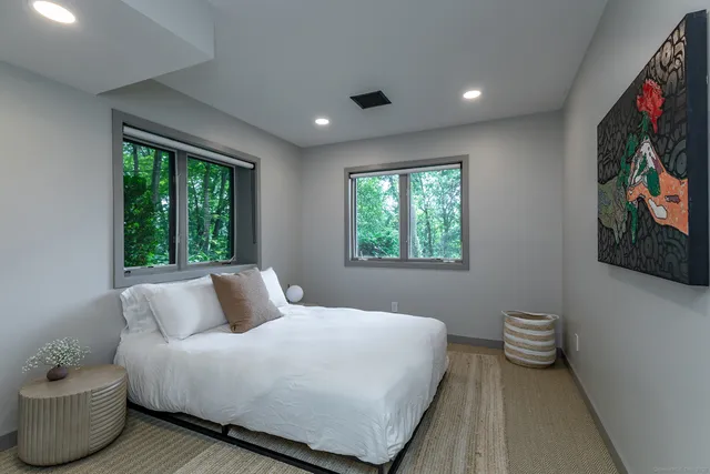 a bedroom with a bed and a large window