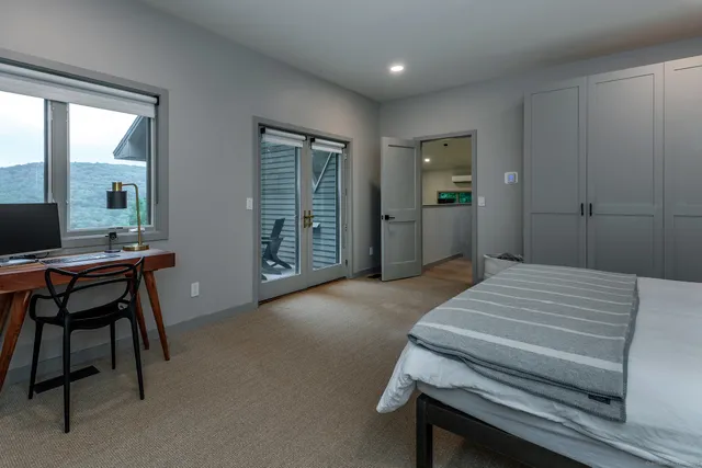 a bedroom with a bed and a desk