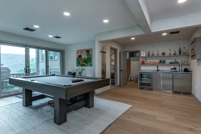 a room with furniture pool table and flat screen tv