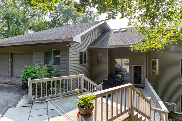 a view of a house with a wooden fence