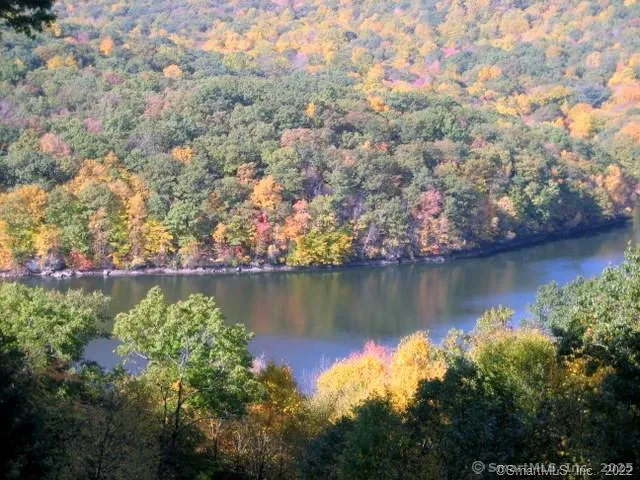 a view of a deck with two chairs and wooden floor