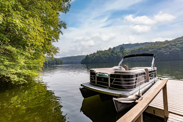 a roof deck with table and chairs