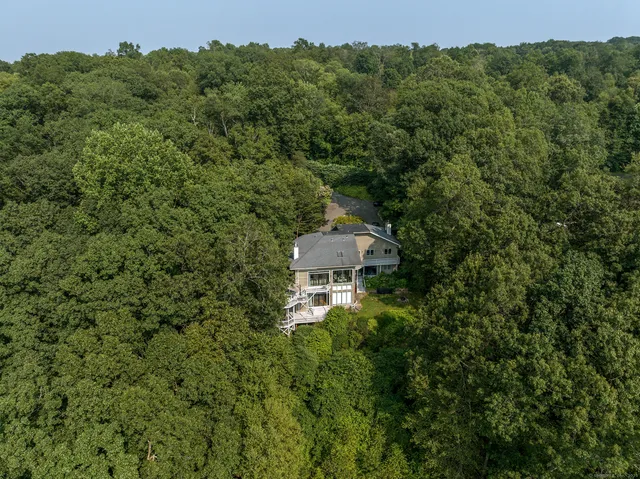 an aerial view of a house with a yard