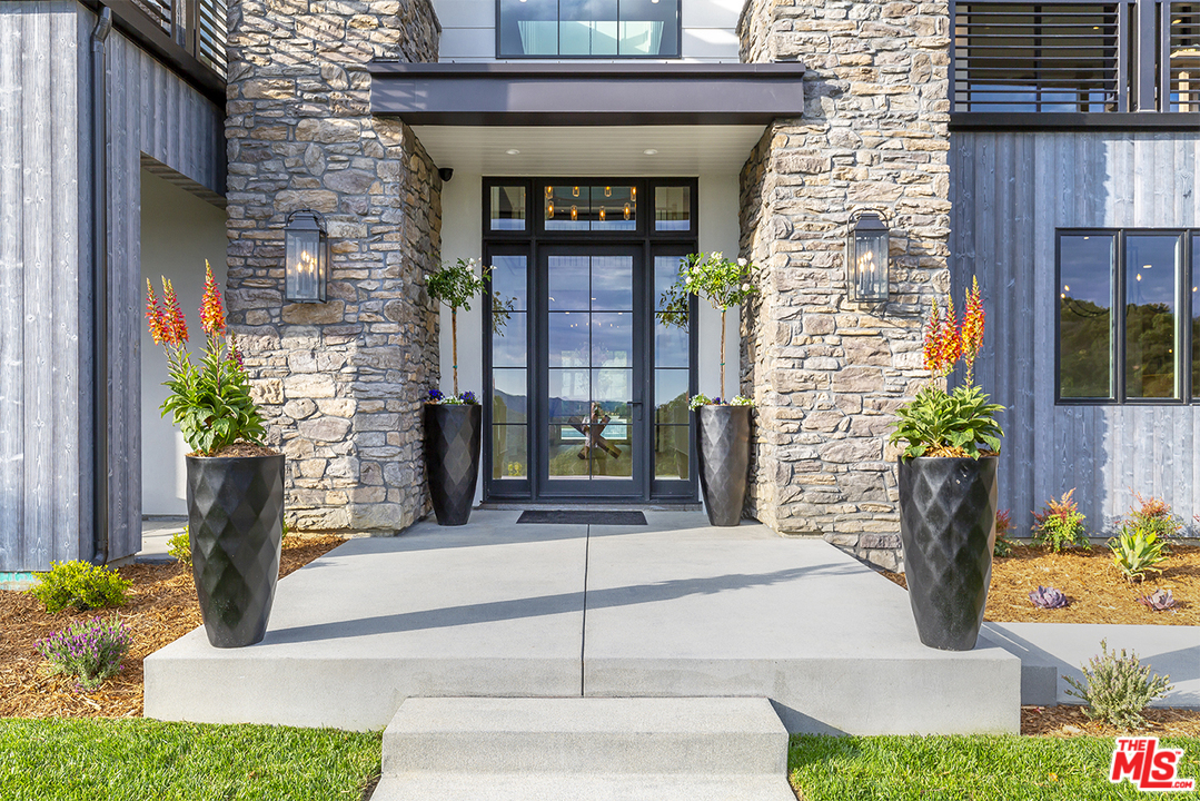 24277 Dry Canyon Cold Creek Road Calabasas, CA 91302 - Photo 5 of 45 a front view of a house with a garden