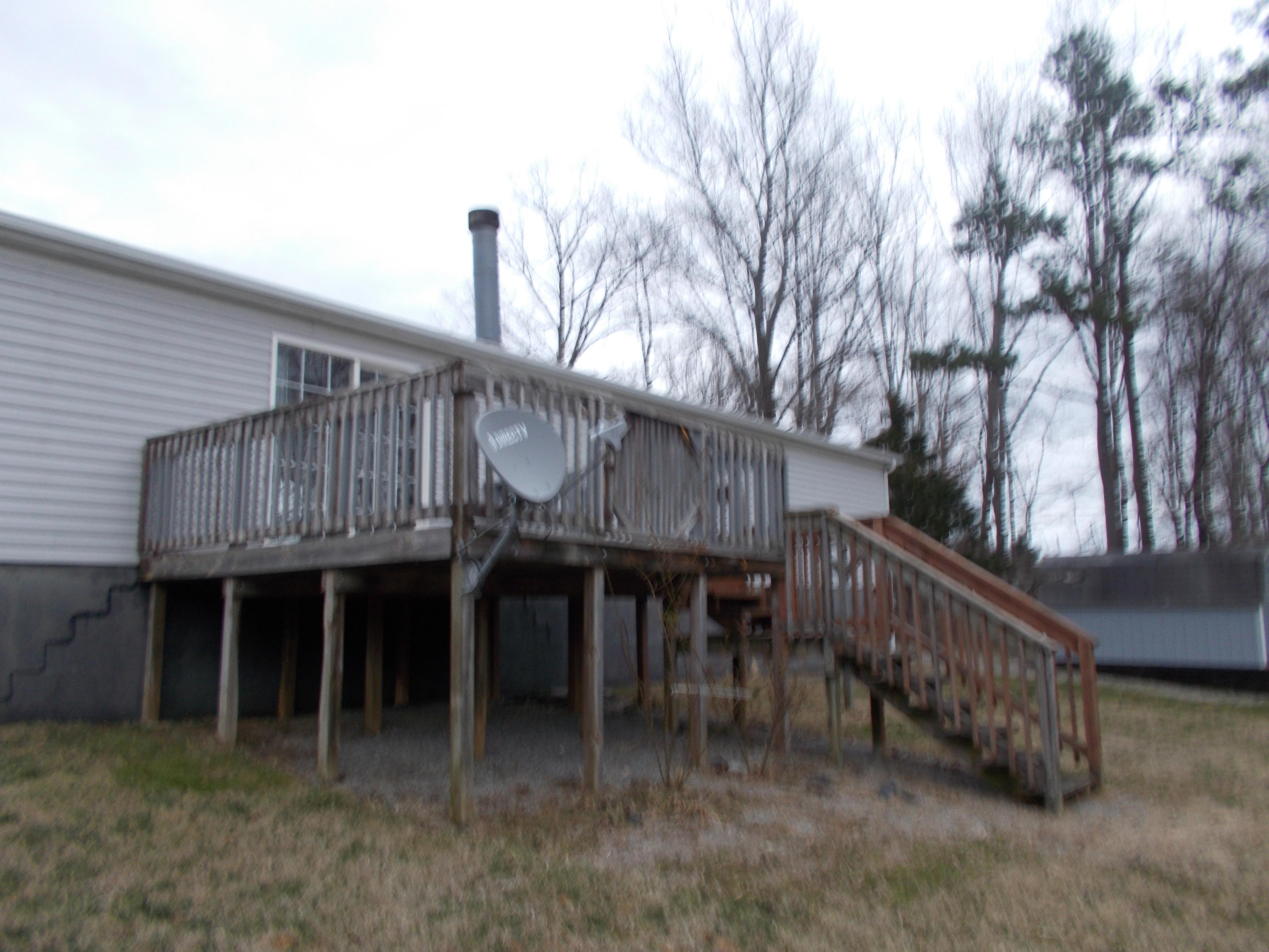 3132 Quarles Road Thaxton, VA 24174 - Photo 11 of 34 a view of a house with wooden deck stairs and furniture