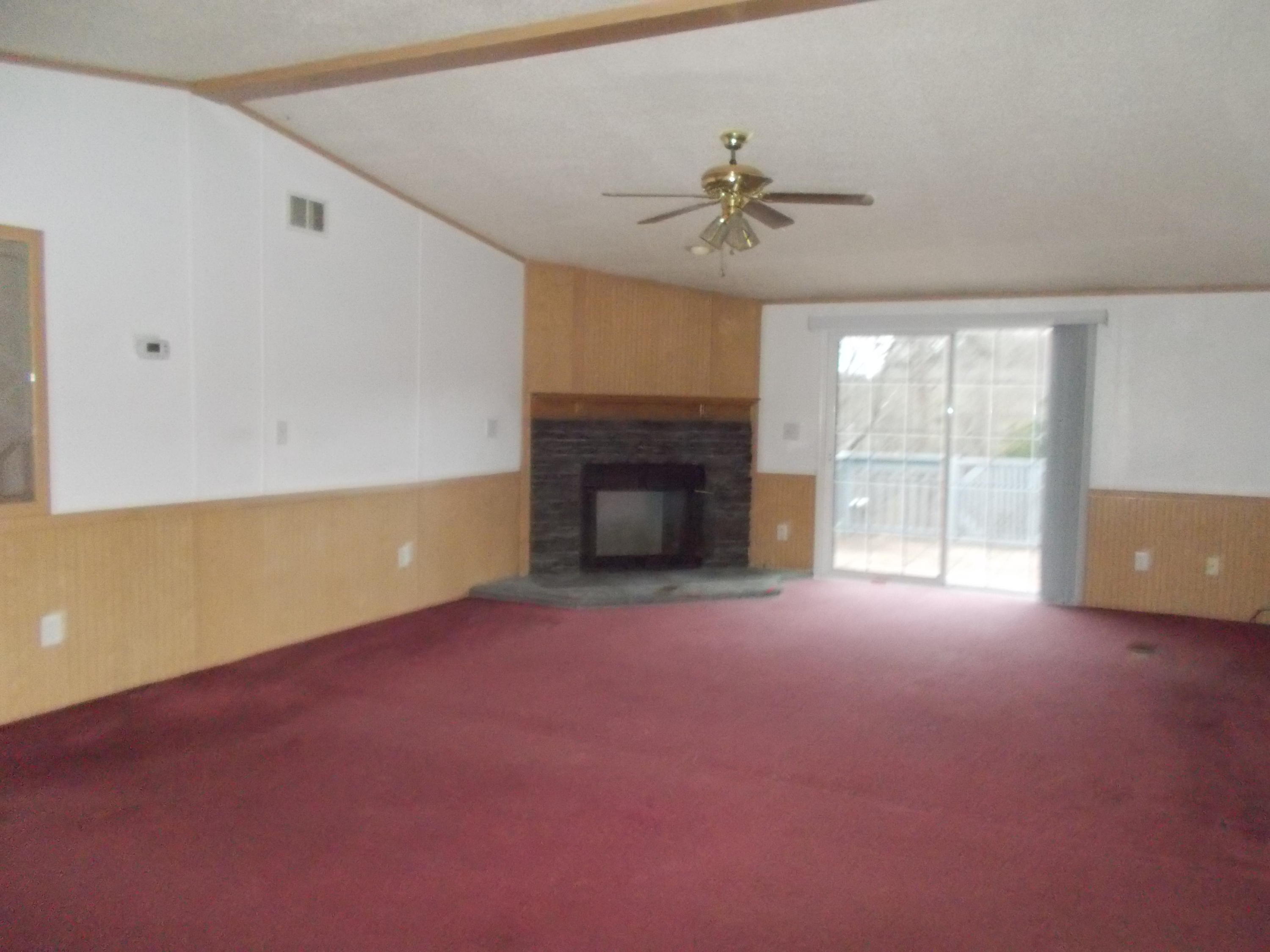 3132 Quarles Road Thaxton, VA 24174 - Photo 14 of 34 a view of an empty room with a fireplace and a window