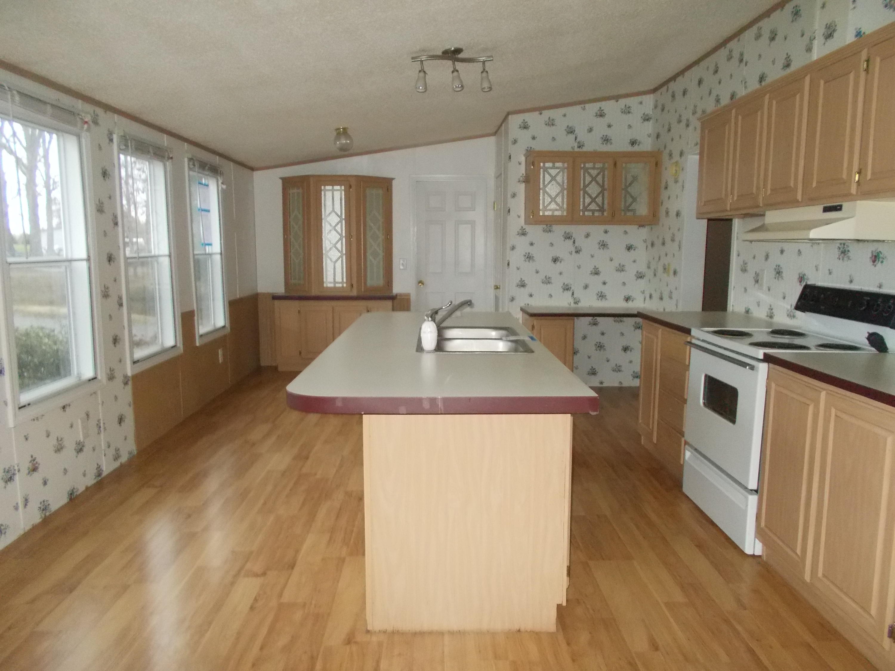 3132 Quarles Road Thaxton, VA 24174 - Photo 16 of 34 a kitchen with granite countertop a sink a counter top space and cabinets