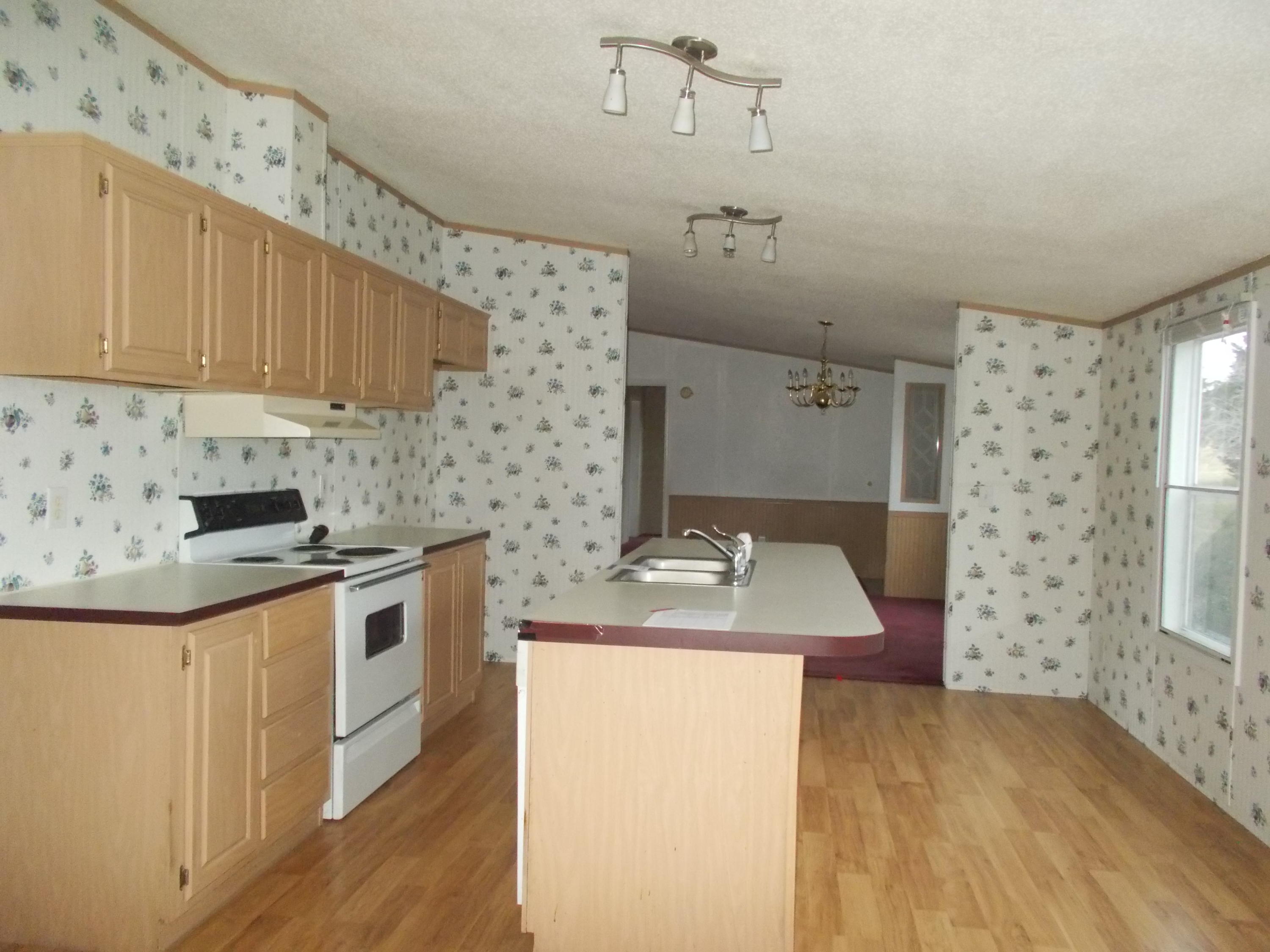 3132 Quarles Road Thaxton, VA 24174 - Photo 17 of 34 a kitchen with stainless steel appliances granite countertop a sink stove and refrigerator