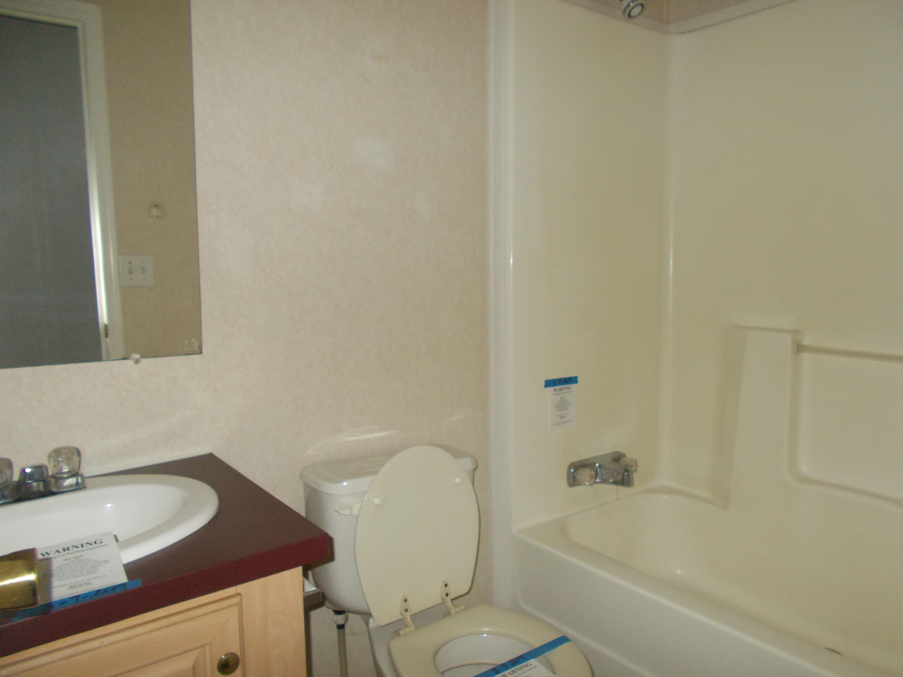 3132 Quarles Road Thaxton, VA 24174 - Photo 23 of 34 a bathroom with a granite countertop sink and a mirror