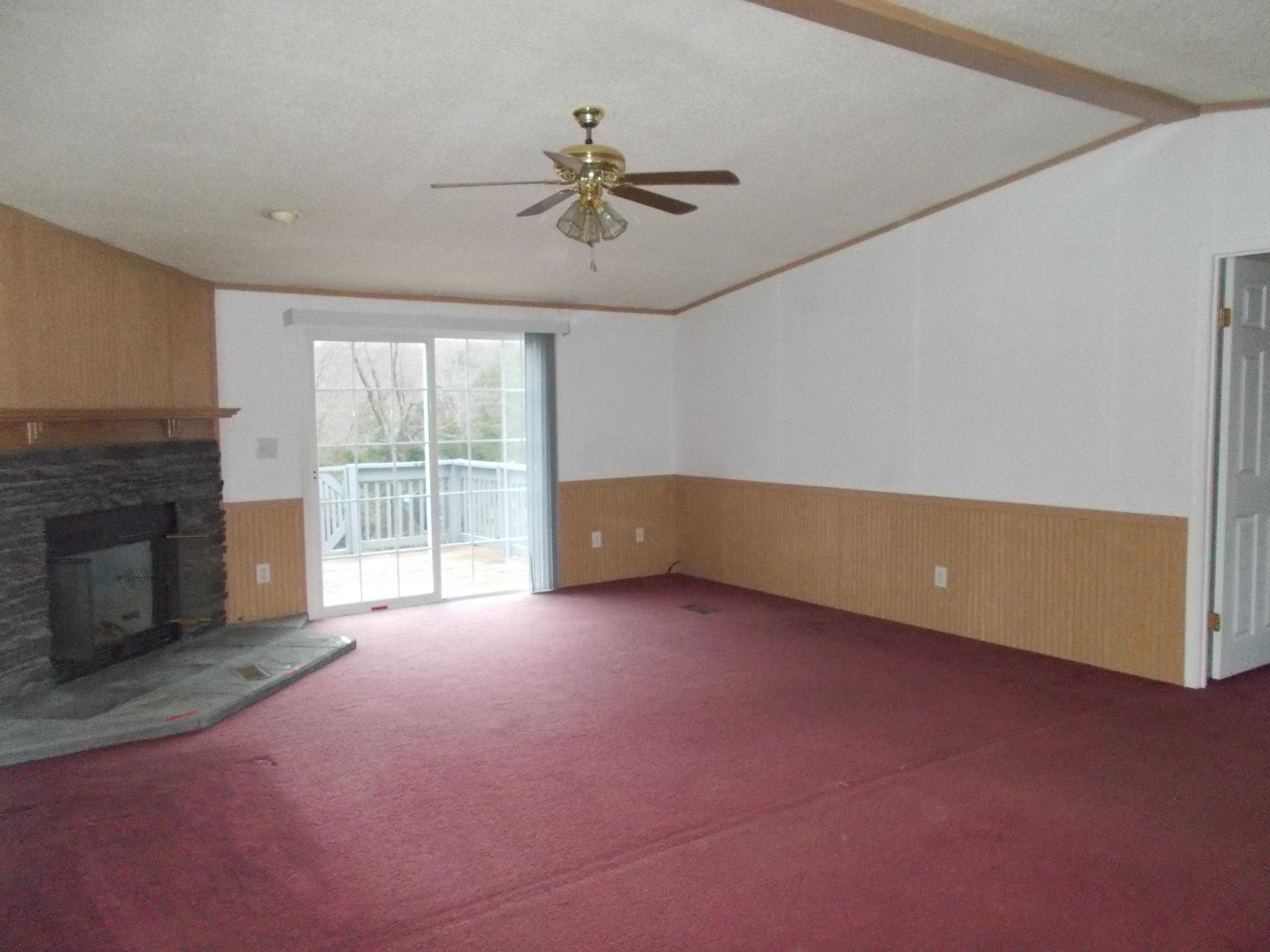 3132 Quarles Road Thaxton, VA 24174 - Photo 27 of 34 a view of an empty room with a fireplace and a window