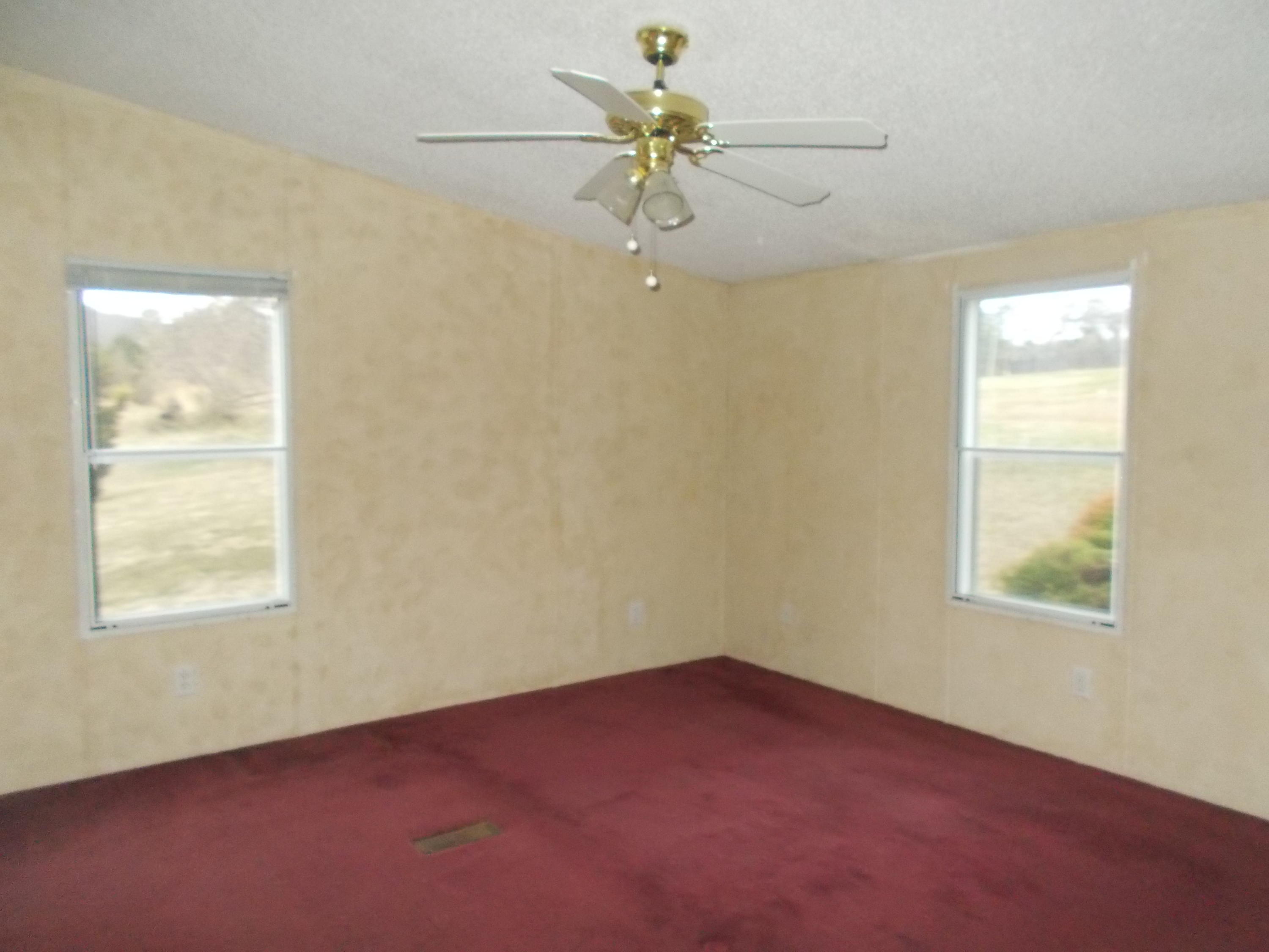 3132 Quarles Road Thaxton, VA 24174 - Photo 28 of 34 an empty room with a window and a fan