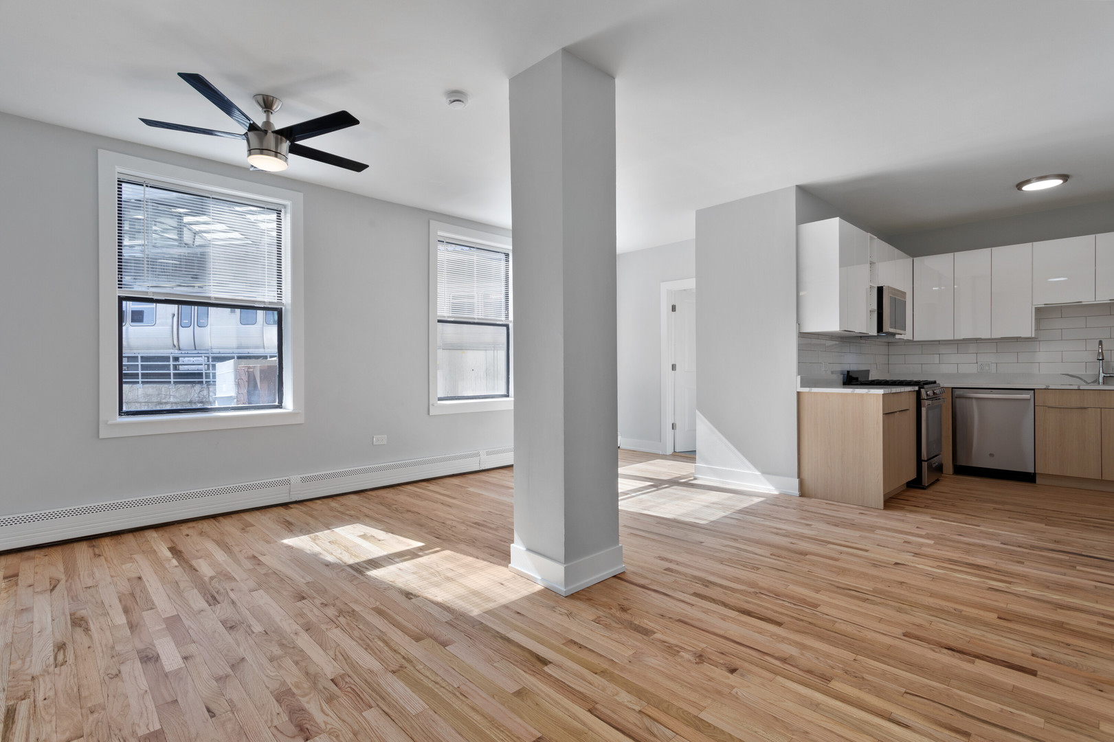 1625 West Howard Street, Unit 216 Chicago, IL 60626 - Photo 2 of 9 a view of a kitchen with wooden floor and a ceiling fan