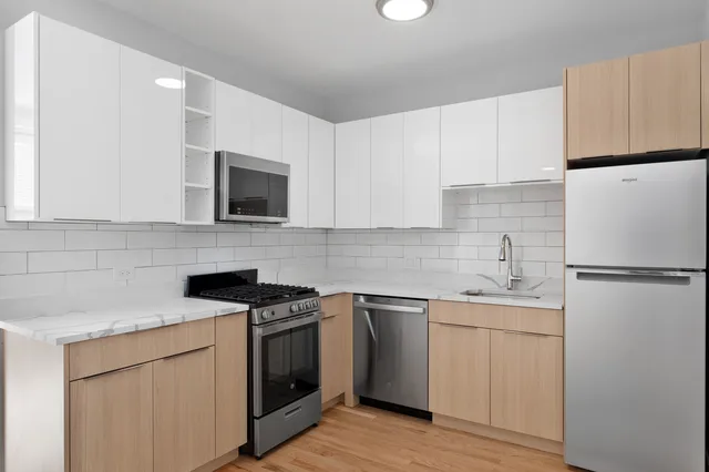 a kitchen with white cabinets sink and white appliances