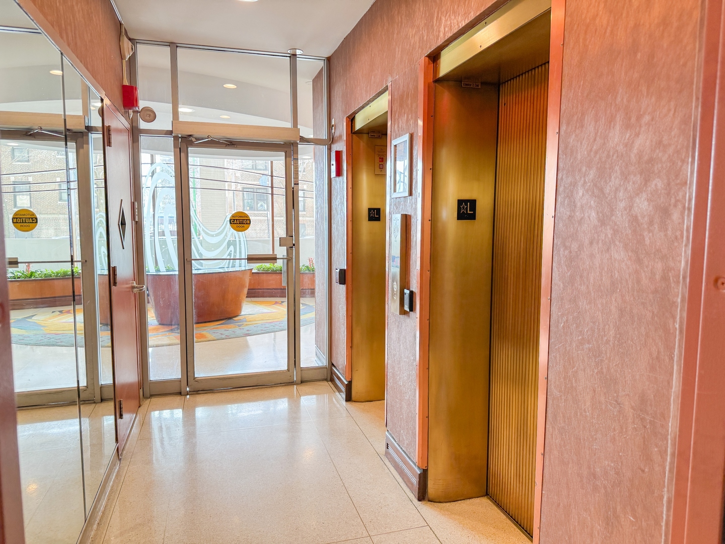 6301 North Sheridan Road, Unit 24E Chicago, IL 60660 - Photo 36 of 52 a bathroom with a glass shower door and mirror