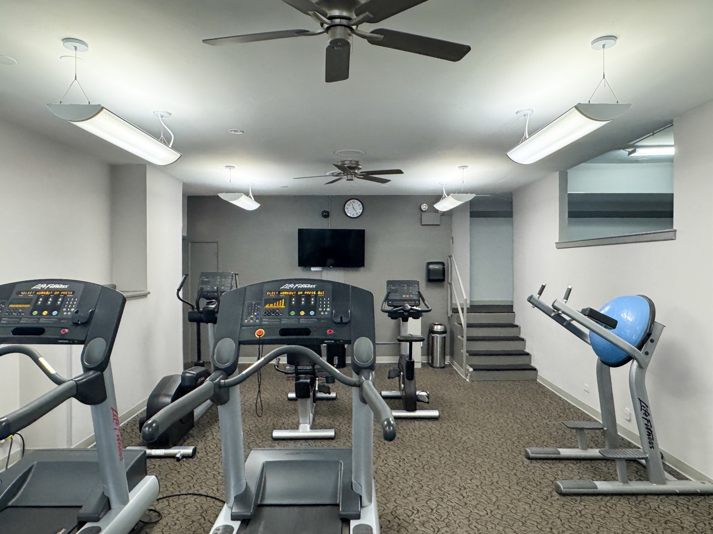 6301 North Sheridan Road, Unit 24E Chicago, IL 60660 - Photo 38 of 52 a room with gym equipment and a flat screen tv