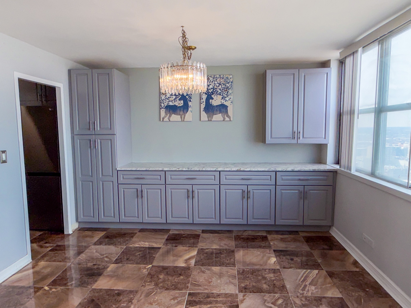 6301 North Sheridan Road, Unit 24E Chicago, IL 60660 - Photo 6 of 52 a view of an empty room with window and wooden floor