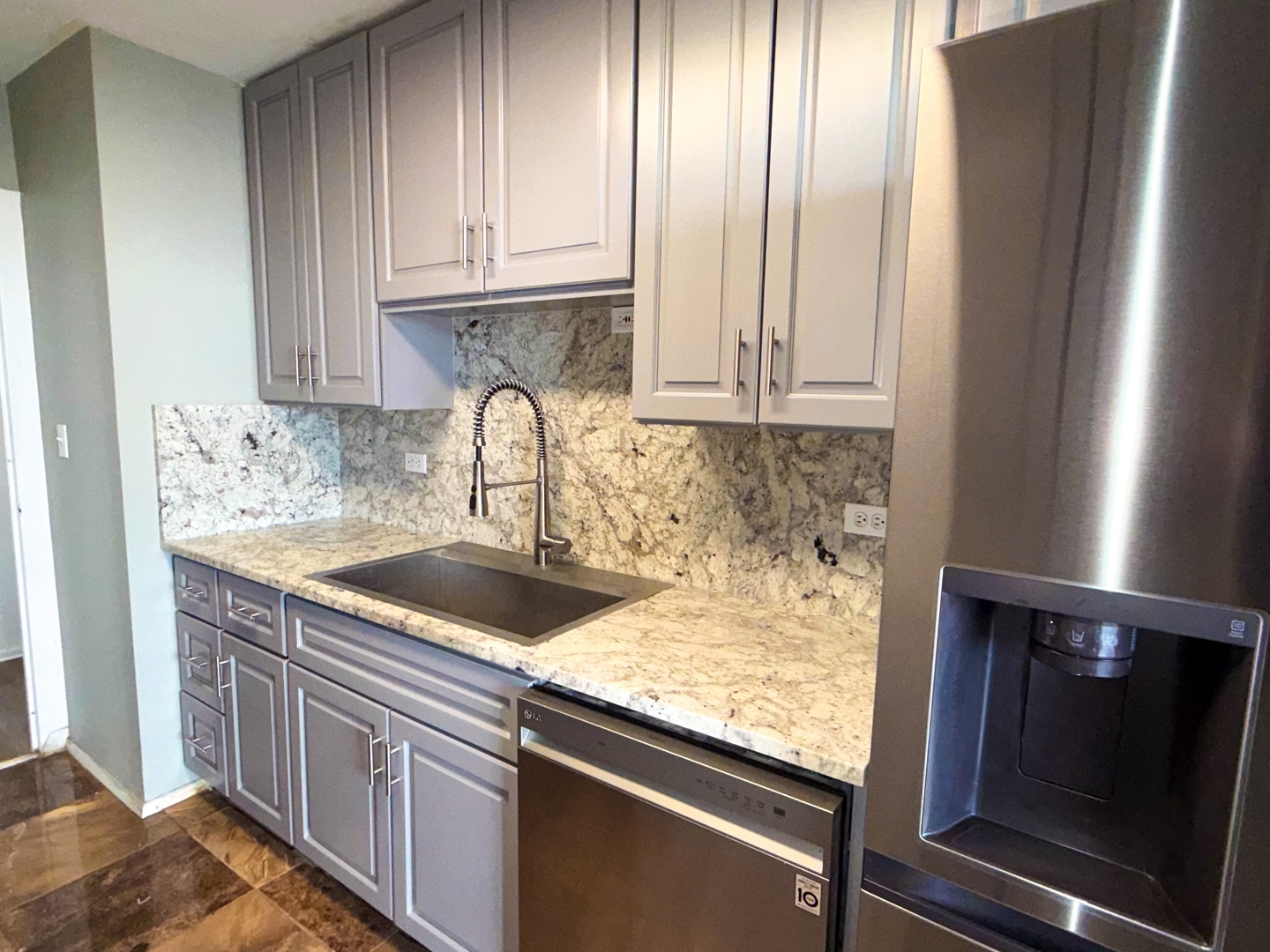 6301 North Sheridan Road, Unit 24E Chicago, IL 60660 - Photo 8 of 52 a kitchen with granite countertop a sink stove and cabinets