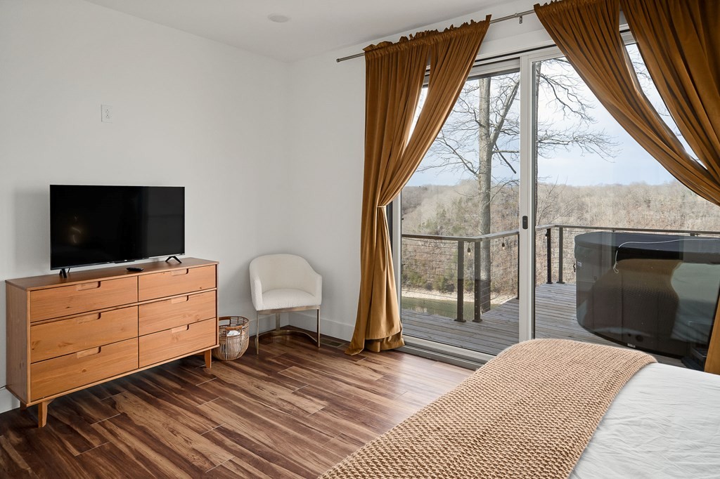 1171 Hutchins Bend Road Sparta, TN 38583 - Photo 27 of 74 a bedroom with a bed and a flat tv screen next to a window