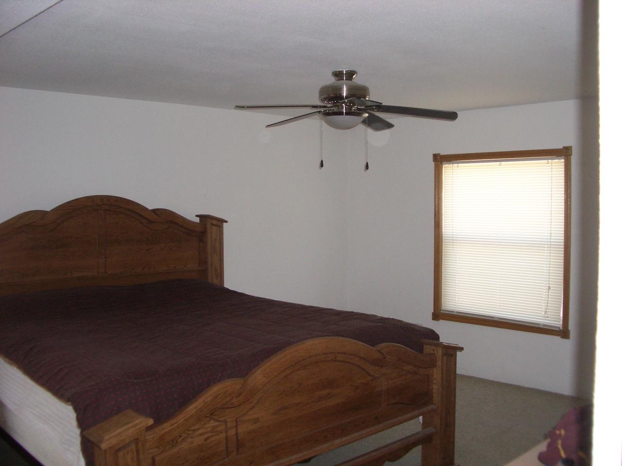 4202 Thorp Road Moxee, WA 98936 - Photo 3 of 8 a bed sitting in a bedroom next to a window