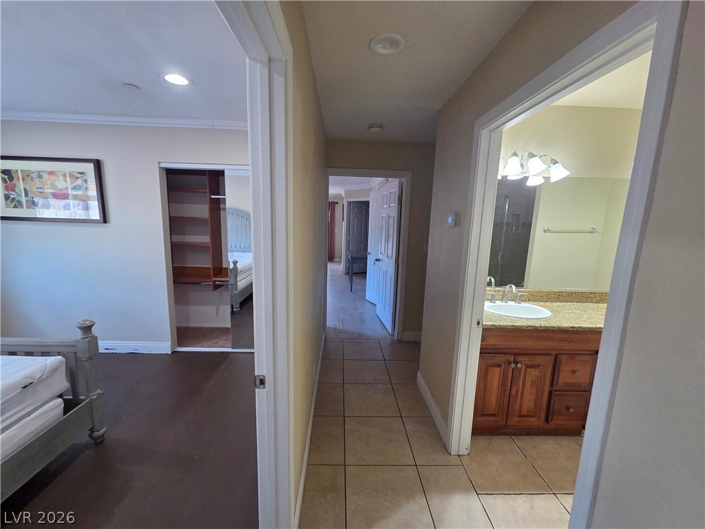 3381 Westwind Road Las Vegas, NV 89146 - Photo 45 of 52 A central hallway offers convenient access to a well-appointed bathroom and a bedroom featuring a sliding closet.