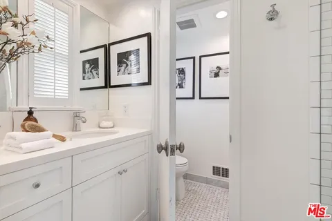a bathroom with a sink a mirror and a shower