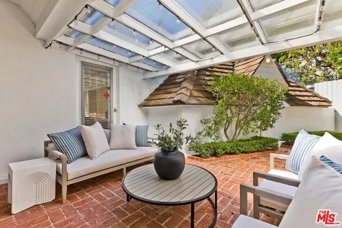 a view of a patio with couches and potted plants