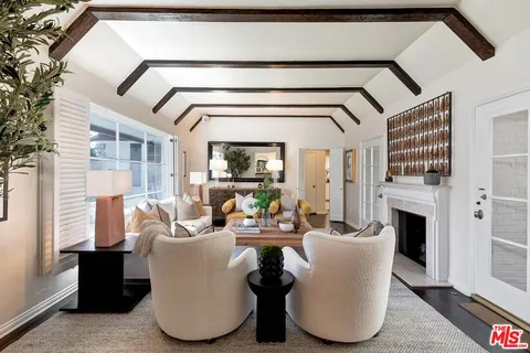 a living room with fireplace furniture and a fireplace