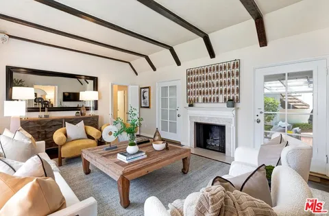 a living room with furniture fireplace and window