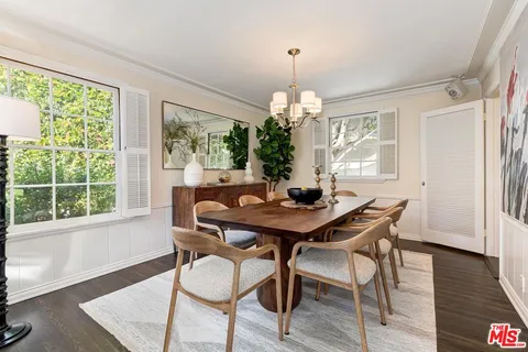 a view of a dining room with furniture wooden floor and chandelier