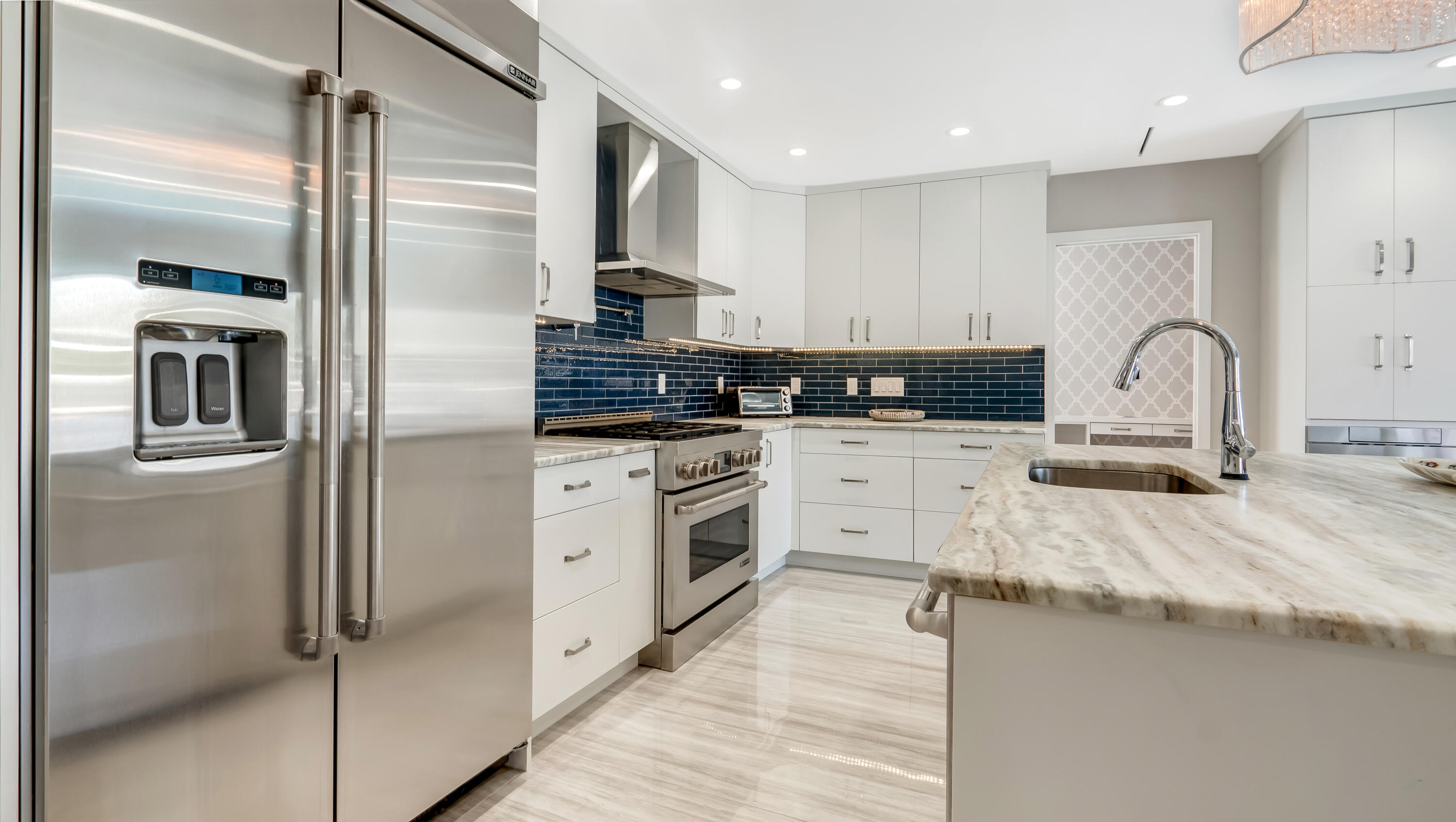 831 Dover Street Boca Raton, FL 33487 - Photo 25 of 71 a kitchen with stainless steel appliances kitchen island granite countertop a refrigerator and a stove top oven