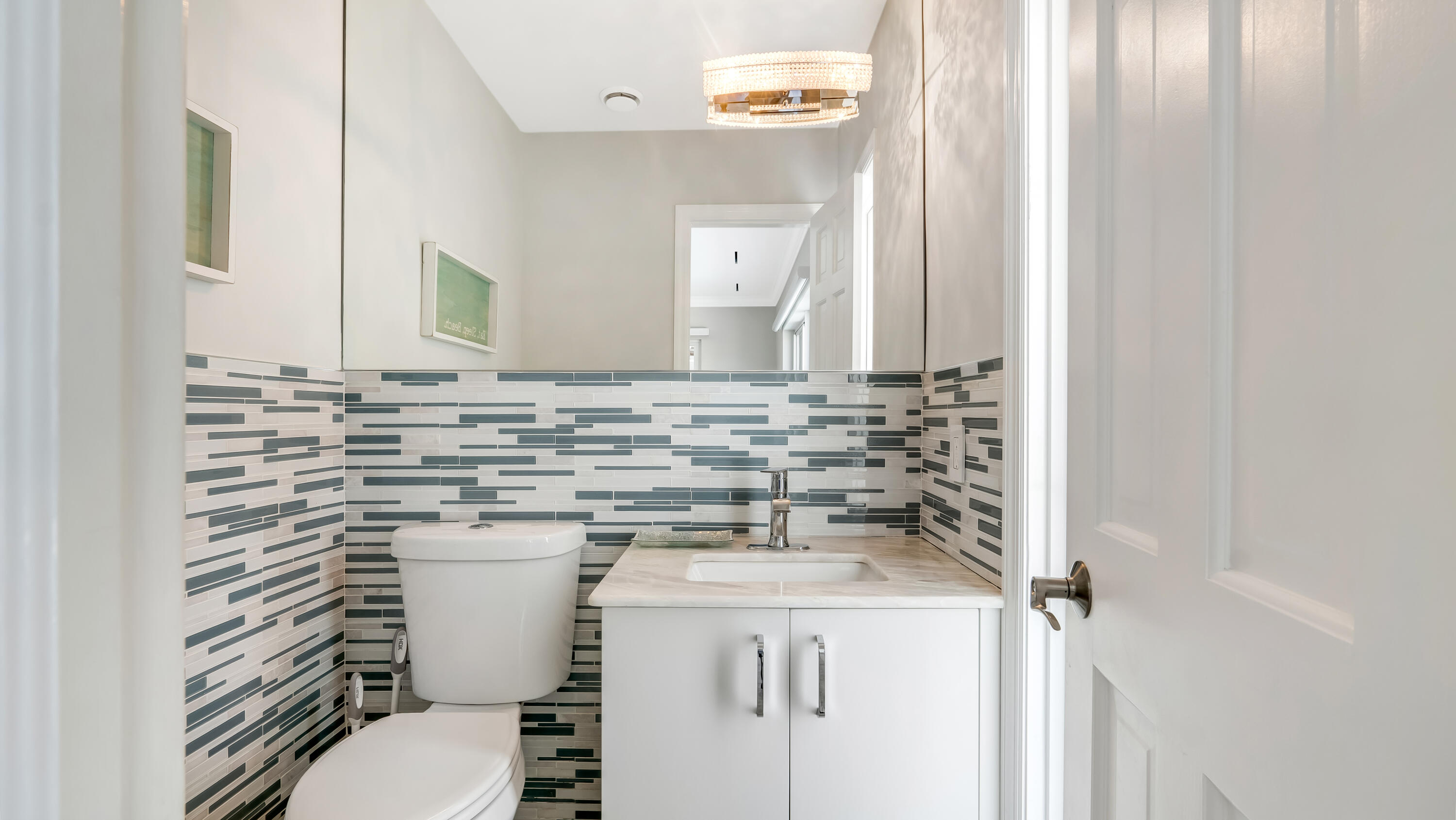 831 Dover Street Boca Raton, FL 33487 - Photo 32 of 71 a bathroom with a sink a toilet and mirror