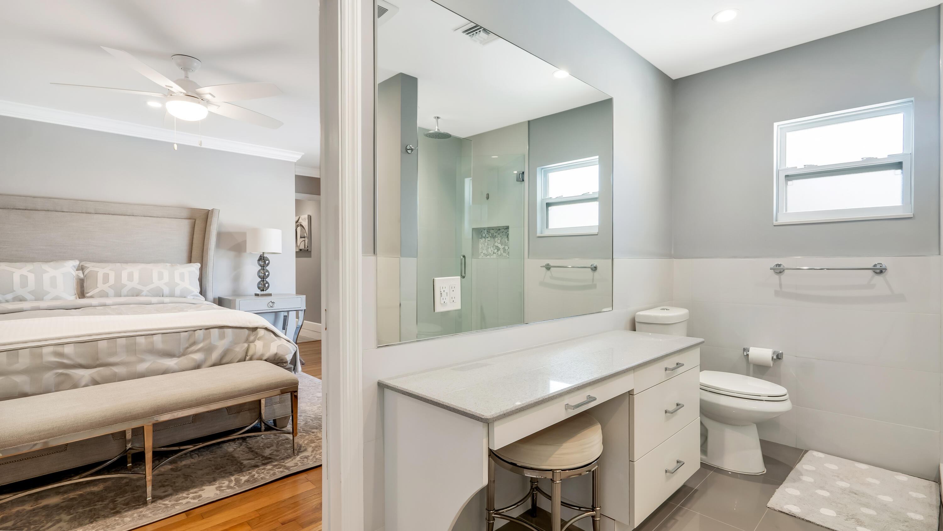 831 Dover Street Boca Raton, FL 33487 - Photo 52 of 71 a en suite bathroom with a granite countertop toilet a sink and a mirror