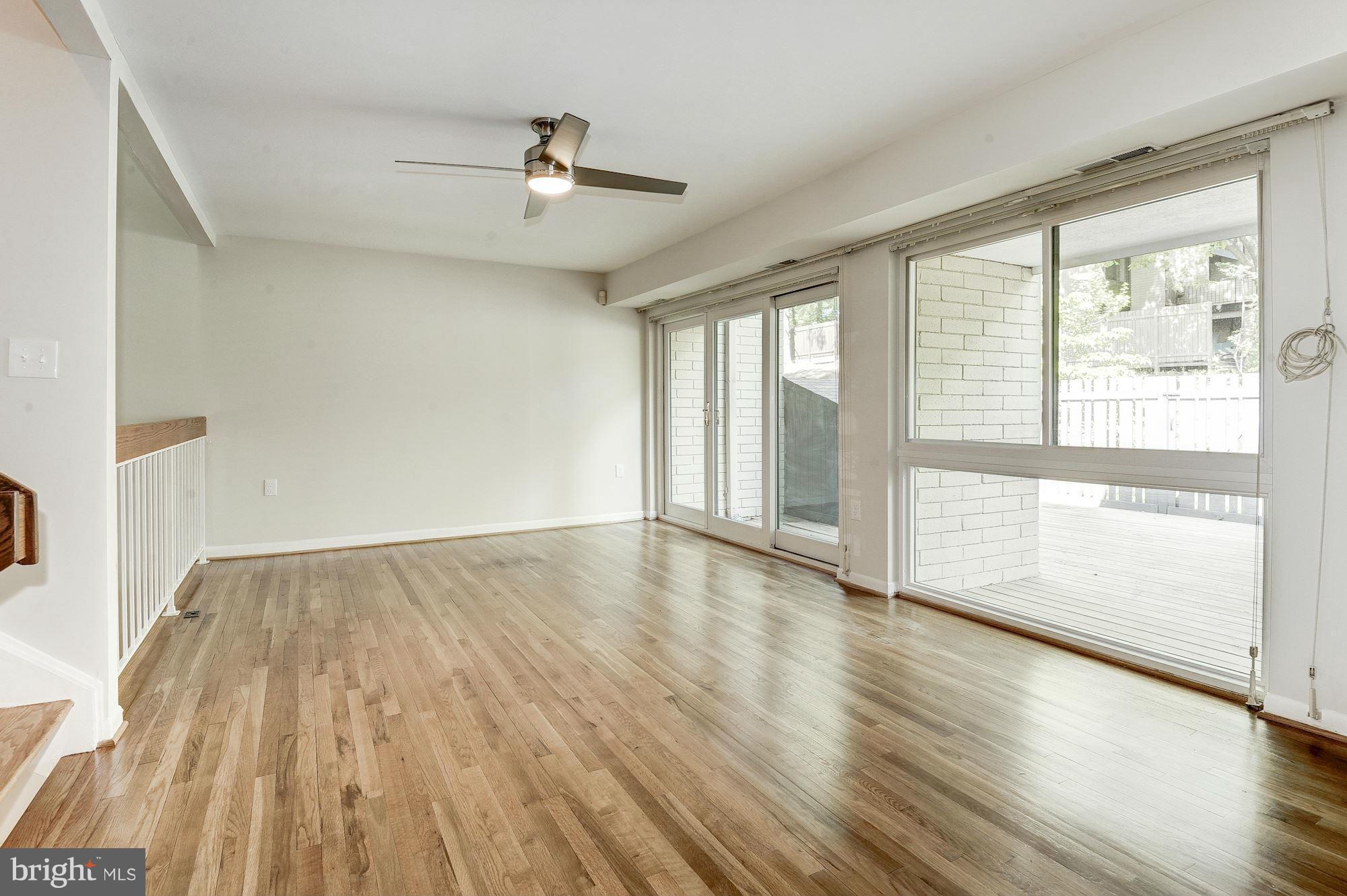 11184 Saffold Way Reston, VA 20190 - Photo 10 of 30 Living Room with rear deck access & glass wall