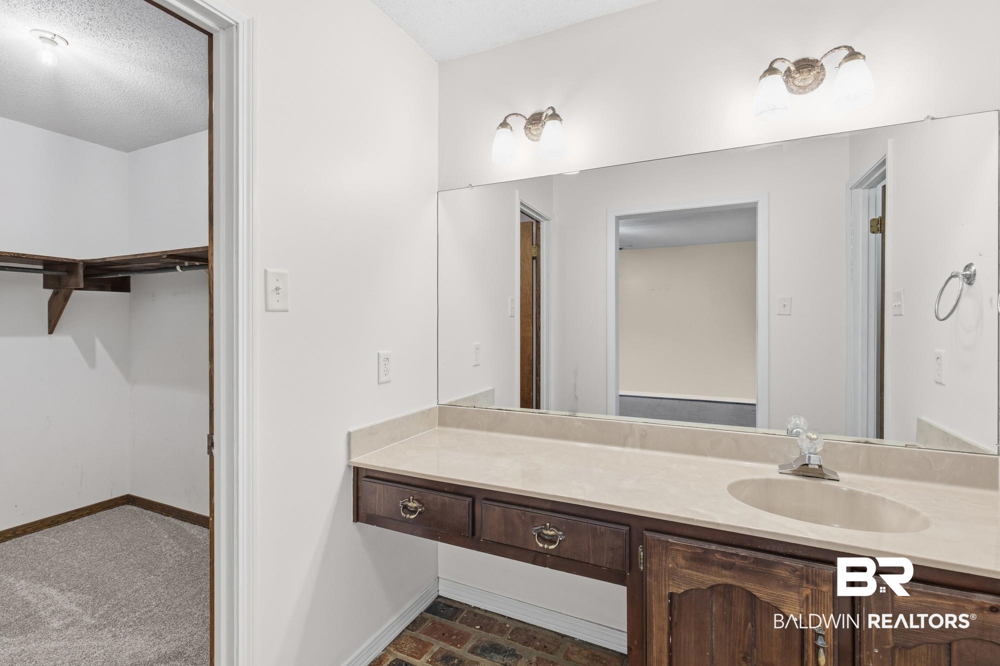 9215 Shiloh Drive Mobile, AL 36695 - Photo 25 of 32 Bathroom with a walk in closet, vanity, and a textured ceiling